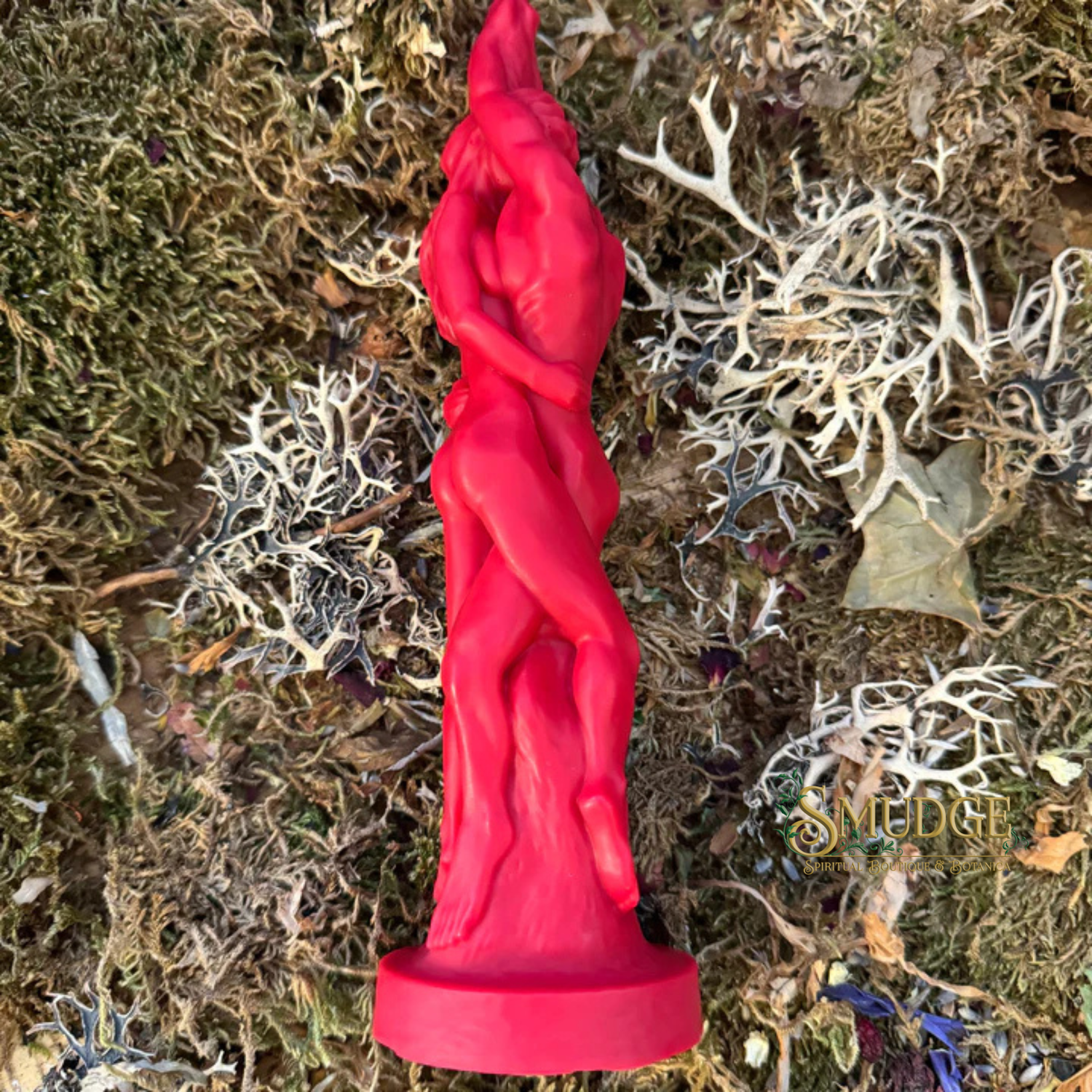 Red candle of an entwined couple on a textured, natural background with 'Smudge' branding.