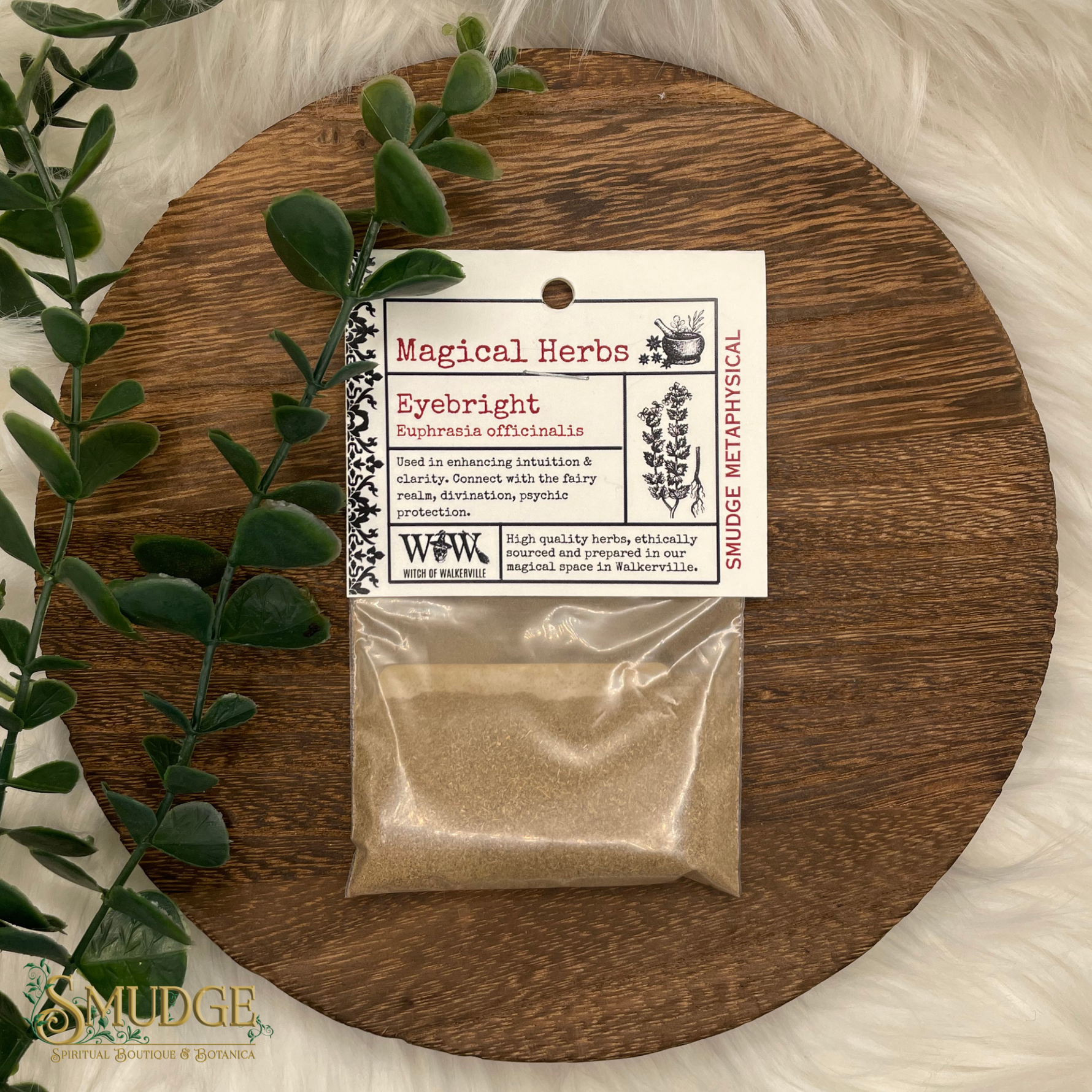 Packaged herbs labeled 'Eyebright' on a wooden board with greenery