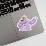 Sticker of a person in a purple hoodie on a laptop keyboard