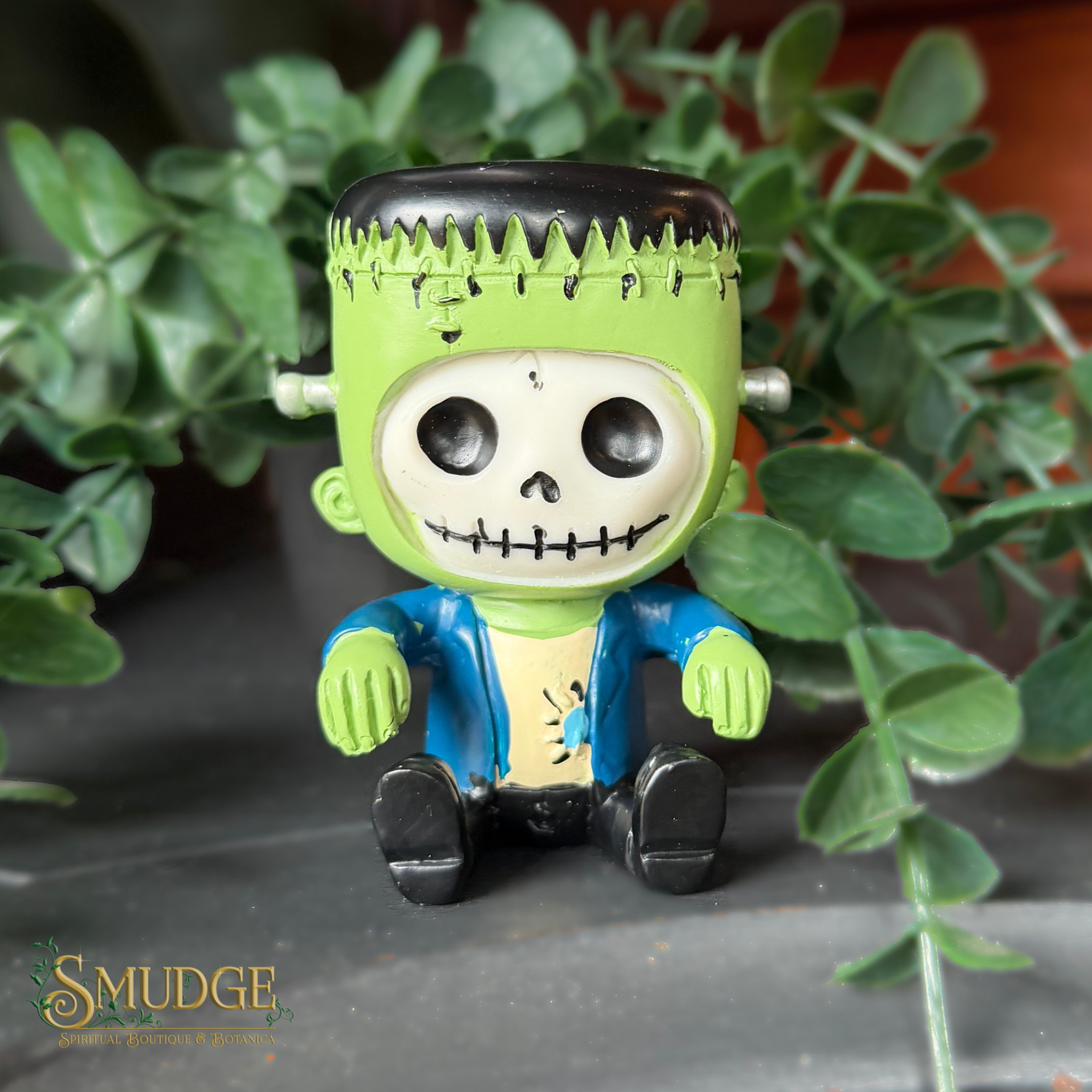 Frankinstein figurine on a leafy background with Smudge logo