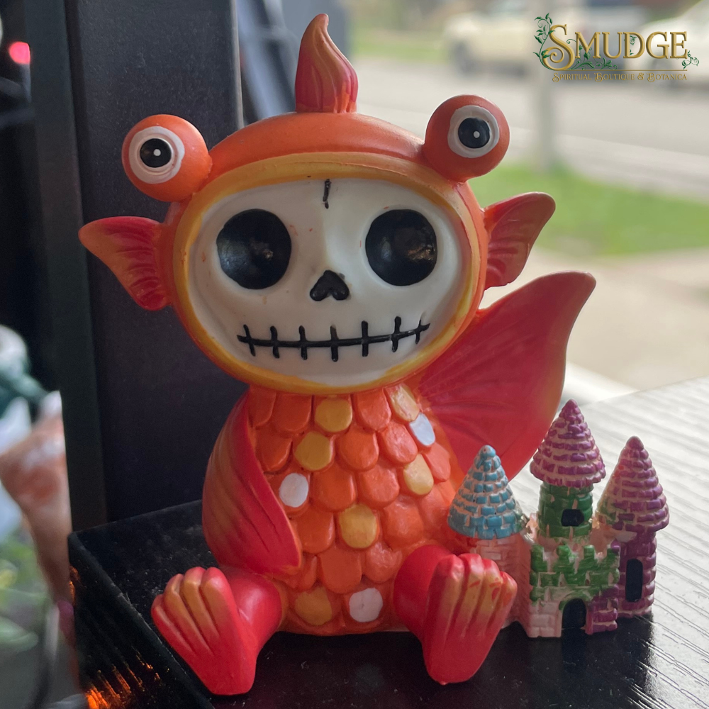 Colorful skeleton figurine with a candy corn design on a blurred background