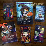 Halloween Forever Oracle card deck and several illustrated oracle cards arranged on a wooden tabletop. The box cover shows a witch holding a jack-o'-lantern, and the cards feature gothic fantasy artwork with names including H.