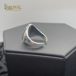 Silver ring on a black jewelry box with 'Smudge' branding.