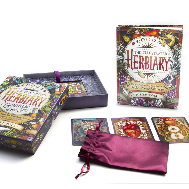 The Illustrated Herbiary box set displayed on a white background, including the illustrated outer box, an open box showing the interior tray, three sample herb cards, and a purple satin drawstring pouch. The author's name, Maria Toll, is visible on the packaging.