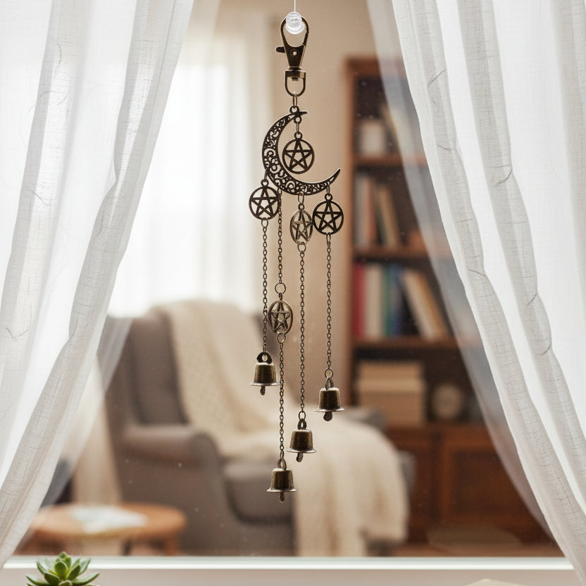 Decorative hanging charm with celestial design on a textured surface