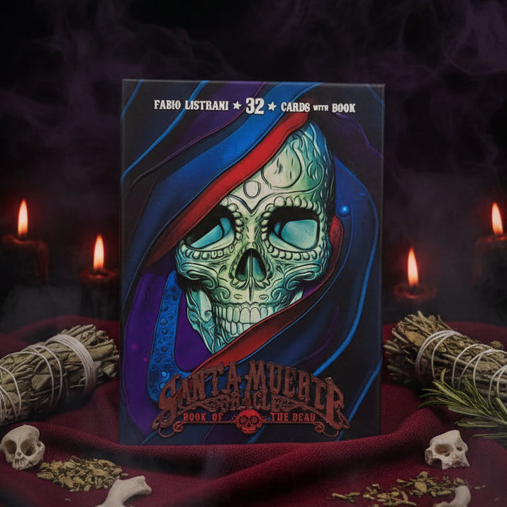 The deck box for 'Santa Muerte Book of the Dead' by Fabio Lustrn, featuring a detailed illustration of a skull under a red and blue veil, displayed on a red fabric surface with decorative flowers in the background.
