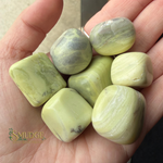 Lime green banded stones in hand with Smudge logo