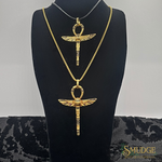 Gold necklace with an ankh pendant on a black bust against a gray background