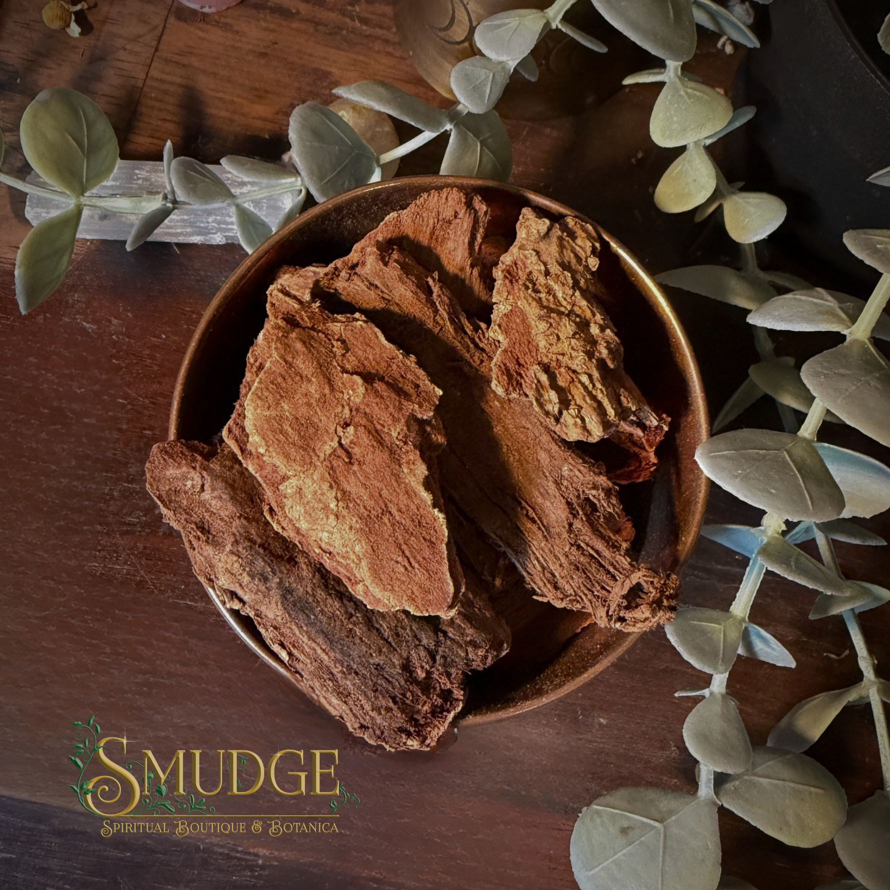 Jezebel root in a bowl on a table surrounded by leaves.