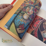 A hand holds an open book or art print showing a colorful illustration of a robed woman holding a pomegranate, with additional artwork visible on the right page. The Smudge Spiritual Practices & Botany logo appears in the lower left corner.
