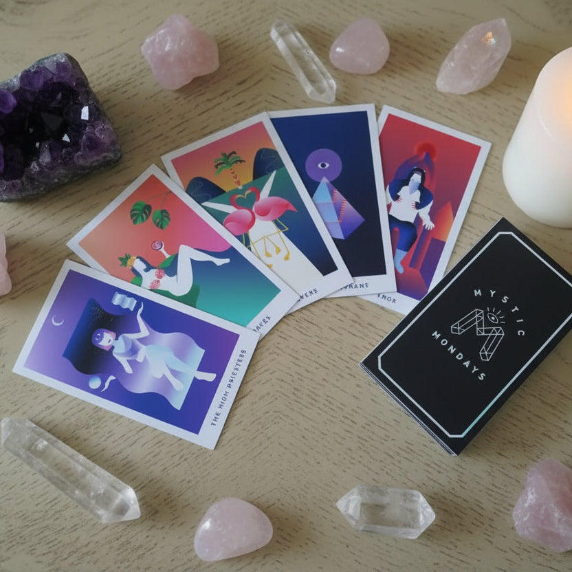Mystic Mondays tarot cards on a table with crystals beside it.