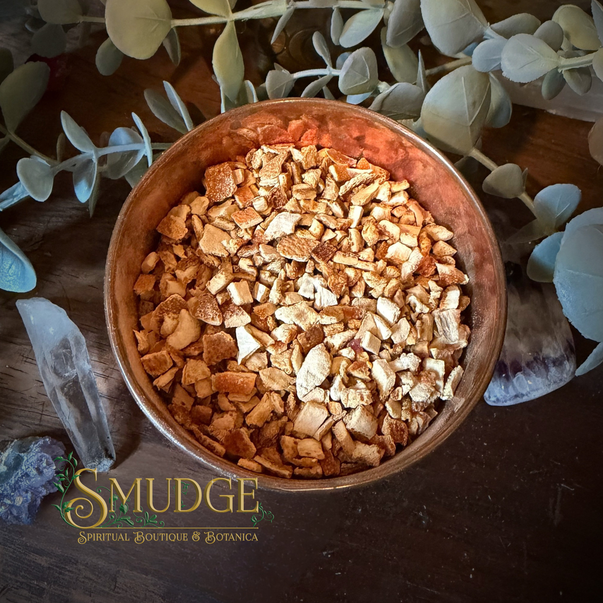 A copper bowl full of dried orange peel pieces. 