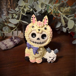 Paco furrybones figurine of a little ghost face in a lama costume with a baby sheep by his feet.