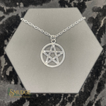 Silver pentagram necklace on a hexagonal silver stand with 'Smudge' branding.