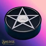 Black candle holder with silver pentagram design on a gradient purple and pink background, featuring the brand 'Smudge'.