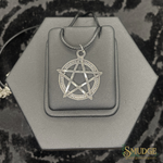 Silver pentagram pendant on a hexagonal gray stand with 'Smudge' branding.