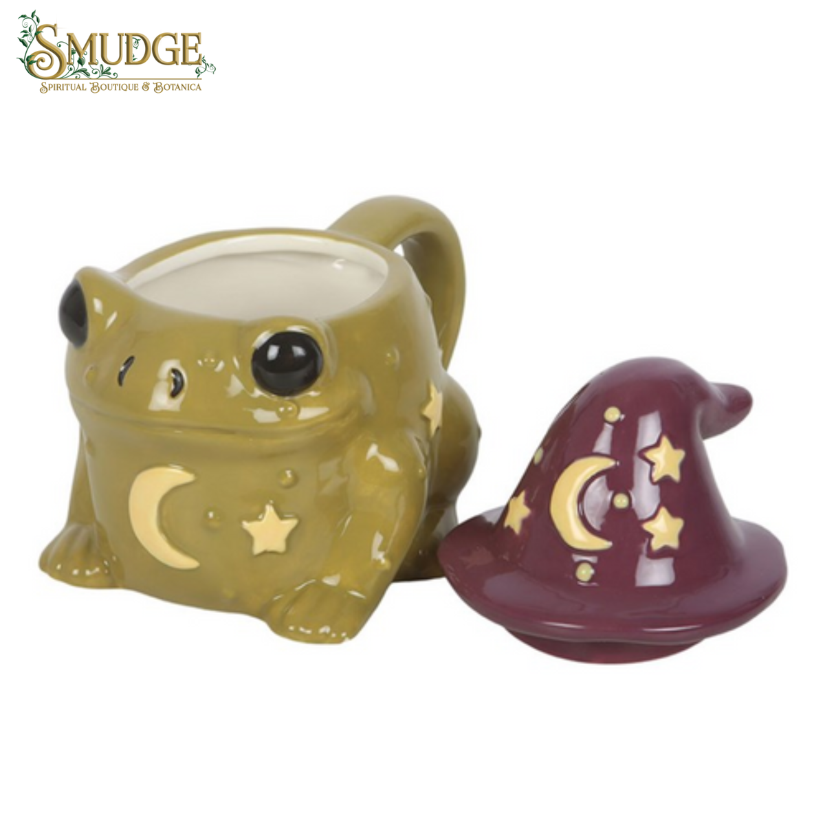 A ceramic mug shaped like a green frog with a handle, decorated with gold crescent moon and star details, shown next to its matching burgundy and gold wizard hat lid on a white background. The 'SMUDGE Apothecary Boutique & Botanica' logo is visible in the top left corner.