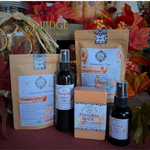 A fall-themed product collection from Smudge & Scrumors featuring Seasonal Spice soap, a Seasonal Matcha spray, a Seasonal Tea spray, and a pumpkin spice bar, arranged with autumn leaves and dried grass.