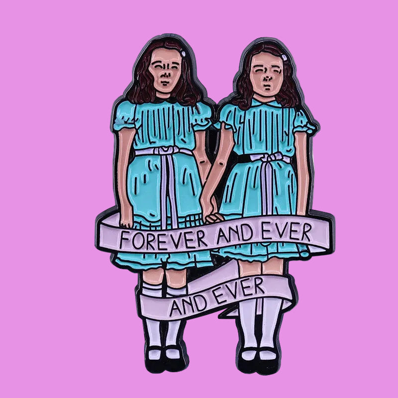 Enamel pin with two identical figures in blue dresses holding a banner with 'Forever and Ever' text on a white background.