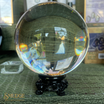 Clear crystal ball on a stand with reflections in a store setting