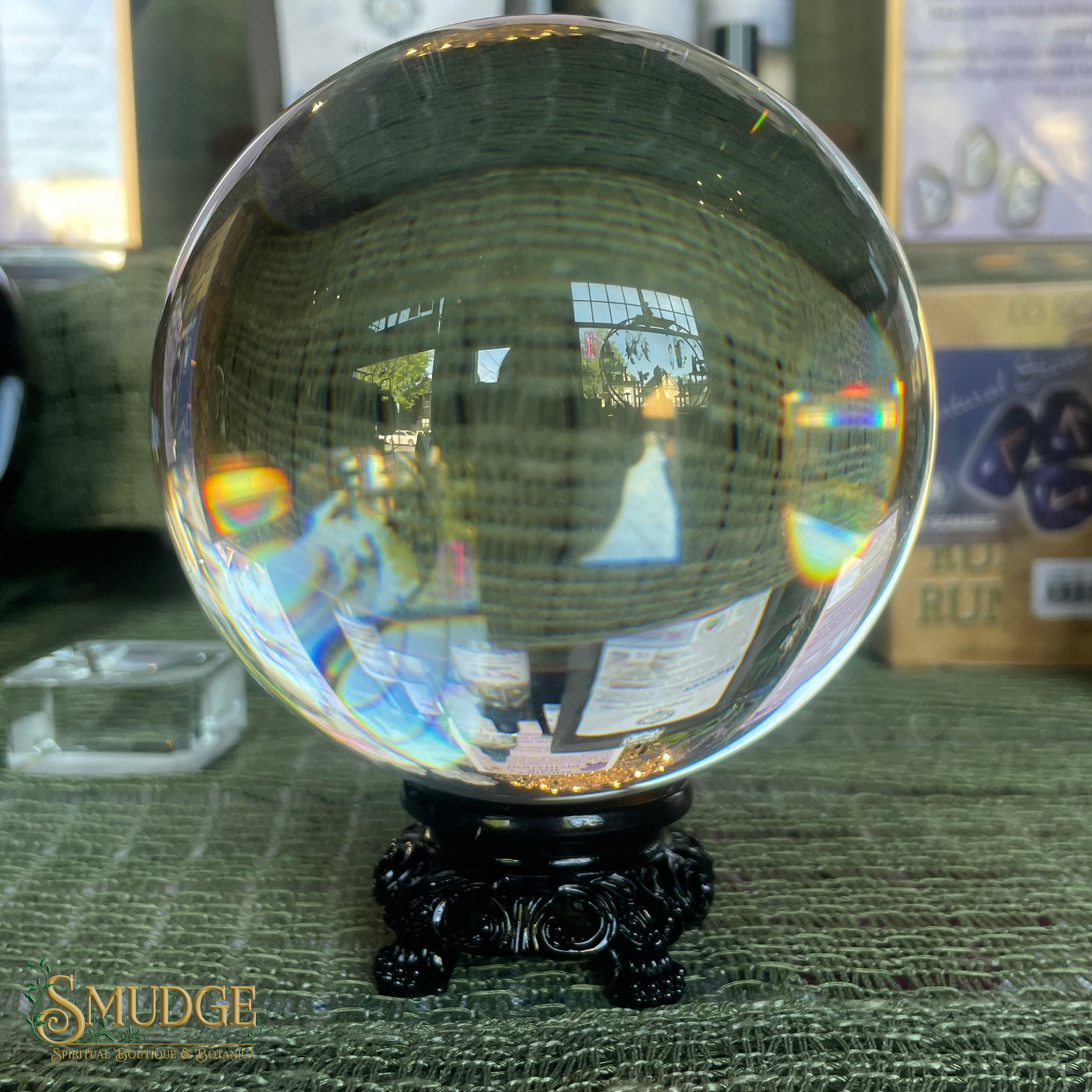 Clear crystal ball on a stand with reflections in a store setting