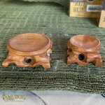 Two wooden stools on a green textured surface with 'Smudge' branding.