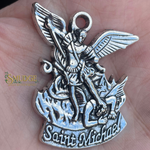 Silver Saint Michael pendant held in a hand