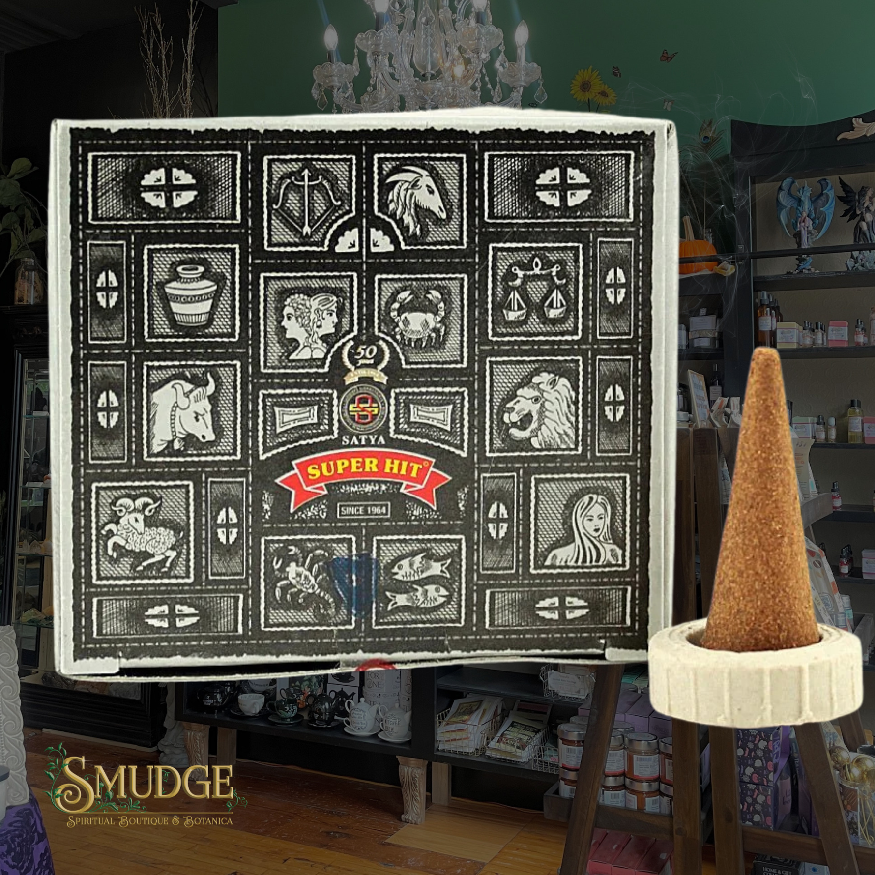 Decorative box with astrological symbols and 'Super Hit' branding in a room setting.