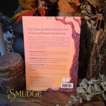 The back cover of a book titled 'Start Your Buddhist Journey with a Clear and Simple Introduction' by Emily Garfield Burke, featuring a peach and pink design with a line-art illustration of a female figure. The book is photographed flat on a dark surface surrounded by dried flowers and greenery, with the 'Smudge' brand logo visible at the bottom.
