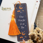 Decorative bookmark with tassel on a white surface, featuring the text 'The Magic Is in You' and the brand 'Smudge'.