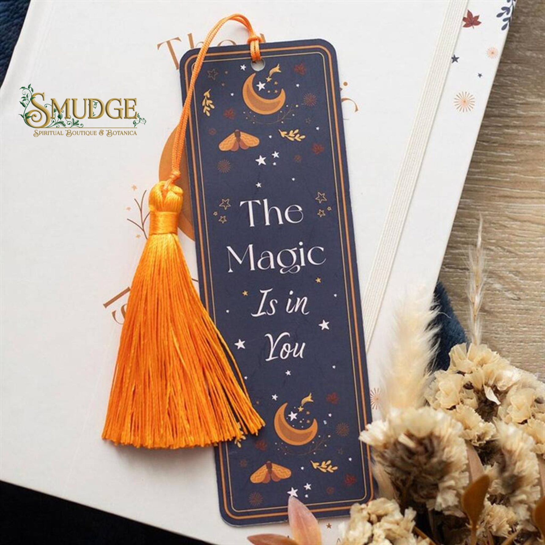 Decorative bookmark with tassel on a white surface, featuring the text 'The Magic Is in You' and the brand 'Smudge'.