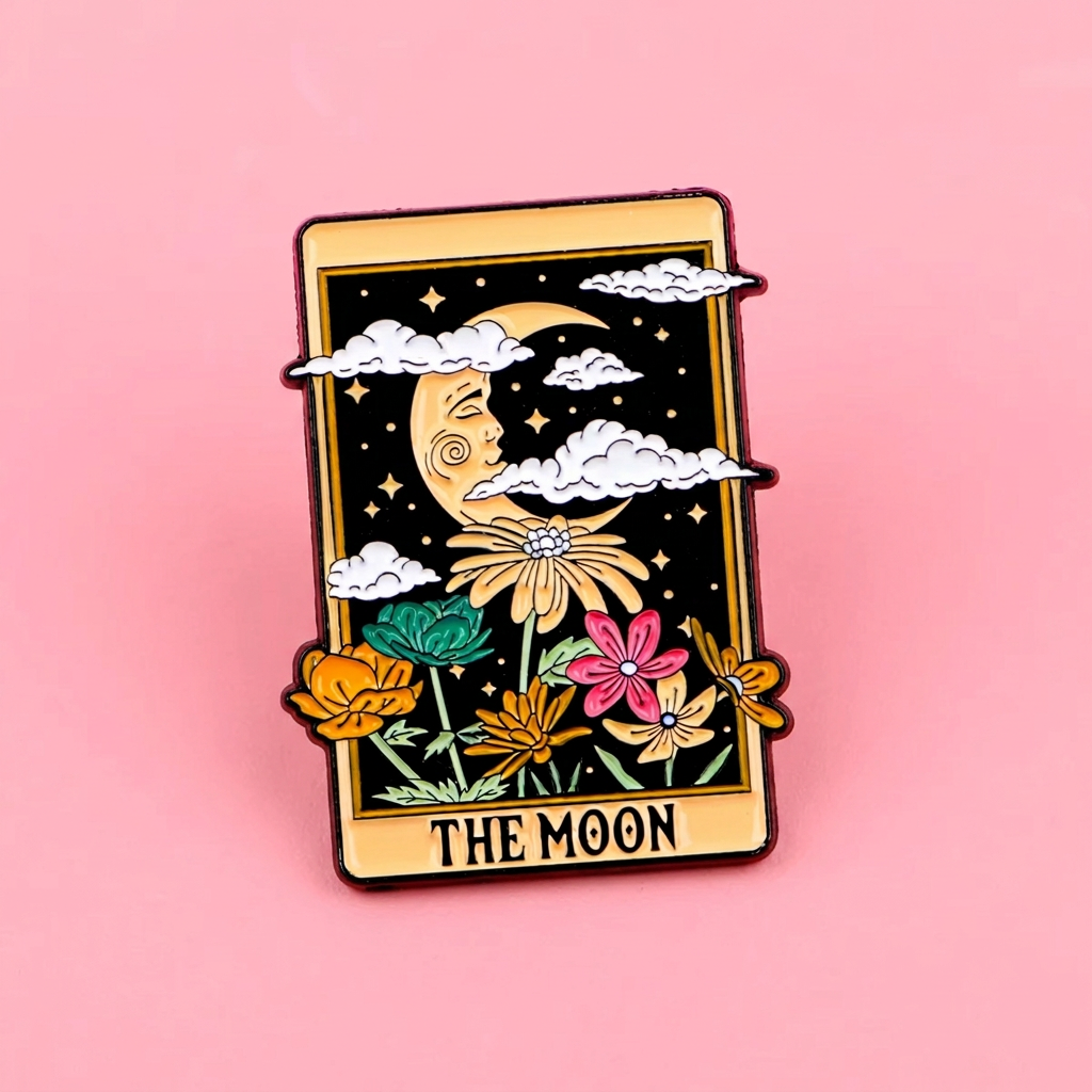 Pin with 'The Moon' tarot card design held in a hand against a pink background