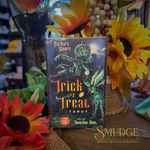 Trick or treat Tarot deck on a wooden table with sunflowers around it.
