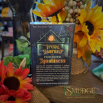 Trick or treat tarot back that says that yourself to fun sized spookiness. Sitting on a wood table with sunflowers around it.