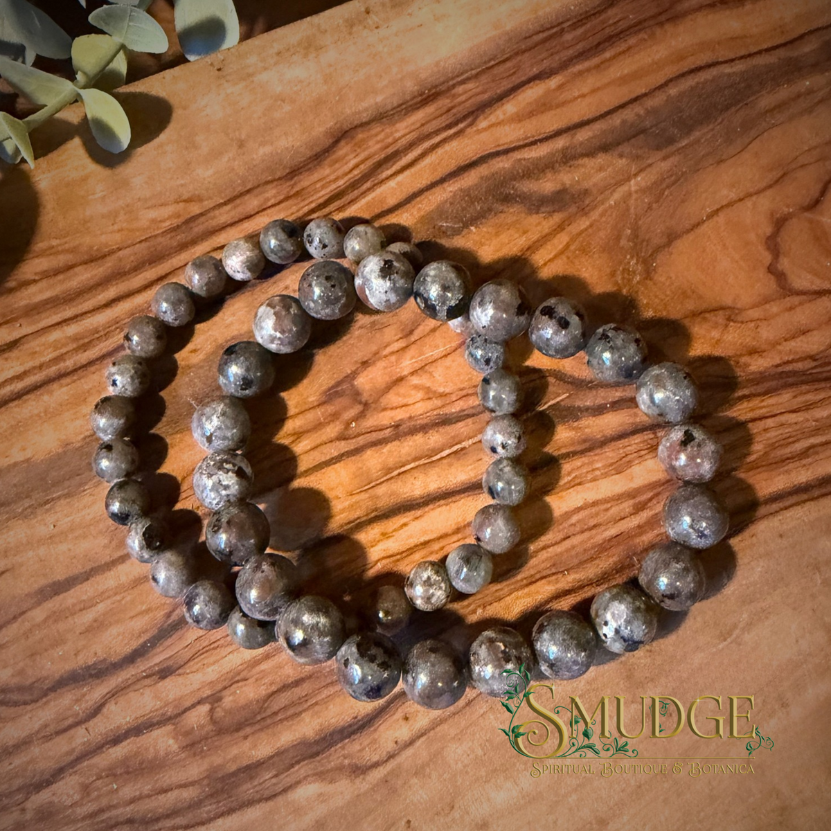 Two yooperlite crystal bracelets on a wooden background